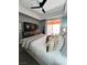 Modern main bedroom with a ceiling fan, balcony access, and a flat screen tv at 23 E Agate Ave # 301, Las Vegas, NV 89123