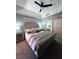 Comfortable main bedroom with a padded headboard, ceiling fan, and gray walls at 23 E Agate Ave # 301, Las Vegas, NV 89123