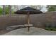 Backyard with a tiki umbrella next to a stone retaining wall at 23 Indian Run Way, Las Vegas, NV 89148
