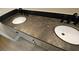 Close-up of bathroom vanity with dual sinks and granite countertop at 23 Indian Run Way, Las Vegas, NV 89148