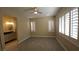 Bedroom with ensuite bathroom, plantation shutters, and modern ceiling fan at 23 Indian Run Way, Las Vegas, NV 89148