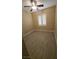Bright bedroom with wood-look floors, ceiling fan, and a window dressed with white shutters at 23 Indian Run Way, Las Vegas, NV 89148