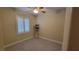 Simple bedroom with ceiling fan, shuttered window and wood look floors at 23 Indian Run Way, Las Vegas, NV 89148