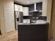 Renovated kitchen with stainless steel refrigerator, white cabinets and modern appliances at 23 Indian Run Way, Las Vegas, NV 89148