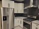 Modern kitchen featuring stainless steel appliances and white cabinets at 23 Indian Run Way, Las Vegas, NV 89148