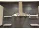 Detailed view of kitchen ventilation hood and custom backsplash at 23 Indian Run Way, Las Vegas, NV 89148
