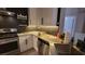 Modern kitchen with stainless steel appliances, white cabinets, and wavy backsplash at 23 Indian Run Way, Las Vegas, NV 89148