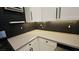 Modern kitchen features granite countertops and black wavy tile backsplash at 23 Indian Run Way, Las Vegas, NV 89148