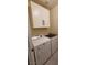 Laundry room showcases updated washer and dryer with white cabinets above at 23 Indian Run Way, Las Vegas, NV 89148
