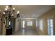 Open-concept living room with a chandelier and lots of natural light at 23 Indian Run Way, Las Vegas, NV 89148