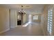 A spacious living room with modern light fixtures and shuttered windows at 23 Indian Run Way, Las Vegas, NV 89148