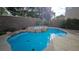 Backyard pool and rock-covered hot tub surrounded by lush greenery at 23 Indian Run Way, Las Vegas, NV 89148