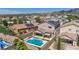Aerial view of a home with a pool, solar panels, and a covered patio at 2449 Daks Loden Ct, Henderson, NV 89044