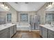 Luxurious bathroom with dual sinks, garden tub, separate shower and neutral color palette at 2449 Daks Loden Ct, Henderson, NV 89044