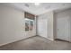 Bright bedroom features neutral tones, a large window, and closet, creating a cozy and inviting space at 2449 Daks Loden Ct, Henderson, NV 89044