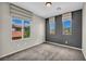 Cozy bedroom with three windows, striped shades, and plush carpeting at 2449 Daks Loden Ct, Henderson, NV 89044