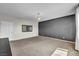 Open, carpeted room with a chandelier, large windows, neutral walls, and a white door at 2449 Daks Loden Ct, Henderson, NV 89044