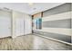 Bedroom with wood floor, neutral walls with gray stripe detail, closet and natural light at 2449 Daks Loden Ct, Henderson, NV 89044