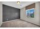 Bright bedroom featuring a window with trees outside and plush carpeting at 2449 Daks Loden Ct, Henderson, NV 89044