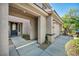 Covered entrance featuring a modern black front door, a light, and a two-car garage at 2449 Daks Loden Ct, Henderson, NV 89044