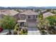 Charming two-story home with desert landscaping, mature trees, and a two-car garage at 2449 Daks Loden Ct, Henderson, NV 89044