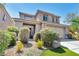 Charming two-story home featuring desert landscaping, mature bushes, and a welcoming entrance at 2449 Daks Loden Ct, Henderson, NV 89044