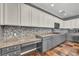 A bright kitchen features granite countertops, mosaic tile backsplash and ample cabinet space at 2449 Daks Loden Ct, Henderson, NV 89044