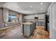 Open kitchen with an island, granite countertops, stainless steel appliances, and a breakfast bar at 2449 Daks Loden Ct, Henderson, NV 89044