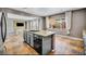 Kitchen features stainless steel appliances, a center island, and is open to the living room at 2449 Daks Loden Ct, Henderson, NV 89044