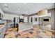 Modern kitchen with stainless appliances, tile floors, granite countertops, and open concept design at 2449 Daks Loden Ct, Henderson, NV 89044