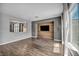 Open living area with wood floors and a custom wood accent wall with a mounted TV at 2449 Daks Loden Ct, Henderson, NV 89044