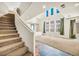 Bright living room features high ceilings, large windows, and a view of the staircase at 2449 Daks Loden Ct, Henderson, NV 89044