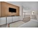 Spacious living room featuring a mounted TV and modern built-in storage at 2449 Daks Loden Ct, Henderson, NV 89044