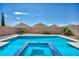 Sparkling backyard pool featuring a spa and well-maintained landscaping at 2449 Daks Loden Ct, Henderson, NV 89044
