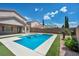 Outdoor oasis featuring a sparkling pool, lush landscaping, and a tranquil backyard ambiance at 2449 Daks Loden Ct, Henderson, NV 89044