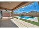 Inviting backyard showcasing a pool, spa, and covered patio, perfect for outdoor relaxation at 2449 Daks Loden Ct, Henderson, NV 89044