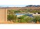 Backyard view showing community homes, desert landscaping, and lake at 25 Canyon Bay Dr, Henderson, NV 89011
