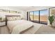 Virtually staged bedroom with a comfortable bed, side tables, and a view of the outdoors at 25 Canyon Bay Dr, Henderson, NV 89011