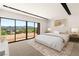 Staged bedroom offers large windows with scenic views, creating a serene and inviting space at 25 Canyon Bay Dr, Henderson, NV 89011