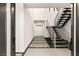 Grand entryway featuring a modern staircase, tiled floor, and a view into the home at 25 Canyon Bay Dr, Henderson, NV 89011