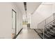 Bright entryway showcasing modern staircase and an open view to the outside at 25 Canyon Bay Dr, Henderson, NV 89011