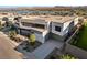 Modern home with a driveway, flat roof, lush landscaping, and a contemporary design at 25 Canyon Bay Dr, Henderson, NV 89011