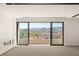 Open living room with modern fireplace and balcony access with city views at 25 Canyon Bay Dr, Henderson, NV 89011