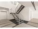 Modern staircase featuring steel railings and open treads, set against a white wall backdrop at 25 Canyon Bay Dr, Henderson, NV 89011