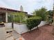 Charming exterior with a tile roof, greenery, and a white wall at 2544 Malabar Ave, Las Vegas, NV 89121