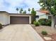 Home featuring an attached two car garage, desert landscaping and mature trees at 2544 Malabar Ave, Las Vegas, NV 89121