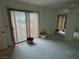 Bright living room with sliding glass doors and mirrored wall at 2544 Malabar Ave, Las Vegas, NV 89121