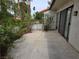 Private backyard patio with mature trees and access gate at 2544 Malabar Ave, Las Vegas, NV 89121