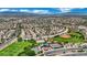 Wide aerial view showcases the community, green spaces, baseball diamonds, and tennis courts in a vibrant neighborhood at 2558 Wiltshire Ave, Henderson, NV 89052