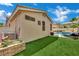 Well-maintained backyard featuring lush artificial turf, inviting pool, and patio furniture for relaxation and enjoyment at 2558 Wiltshire Ave, Henderson, NV 89052